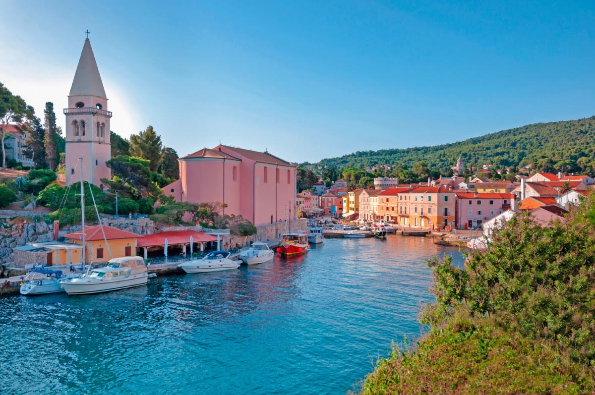 Veli Lošinj church tower above the turquoise harbour